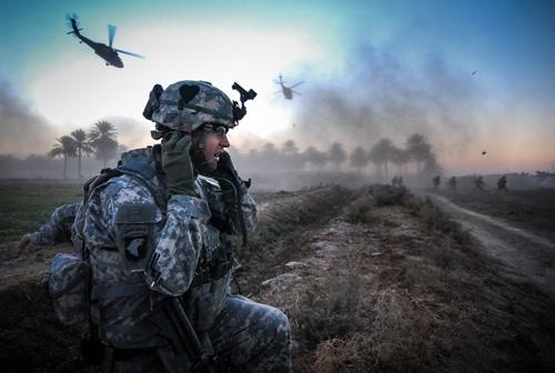 Ben Brody in uniform in Aphganistan with helicopters in distance